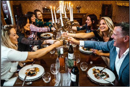 People eating food at a dinner table.